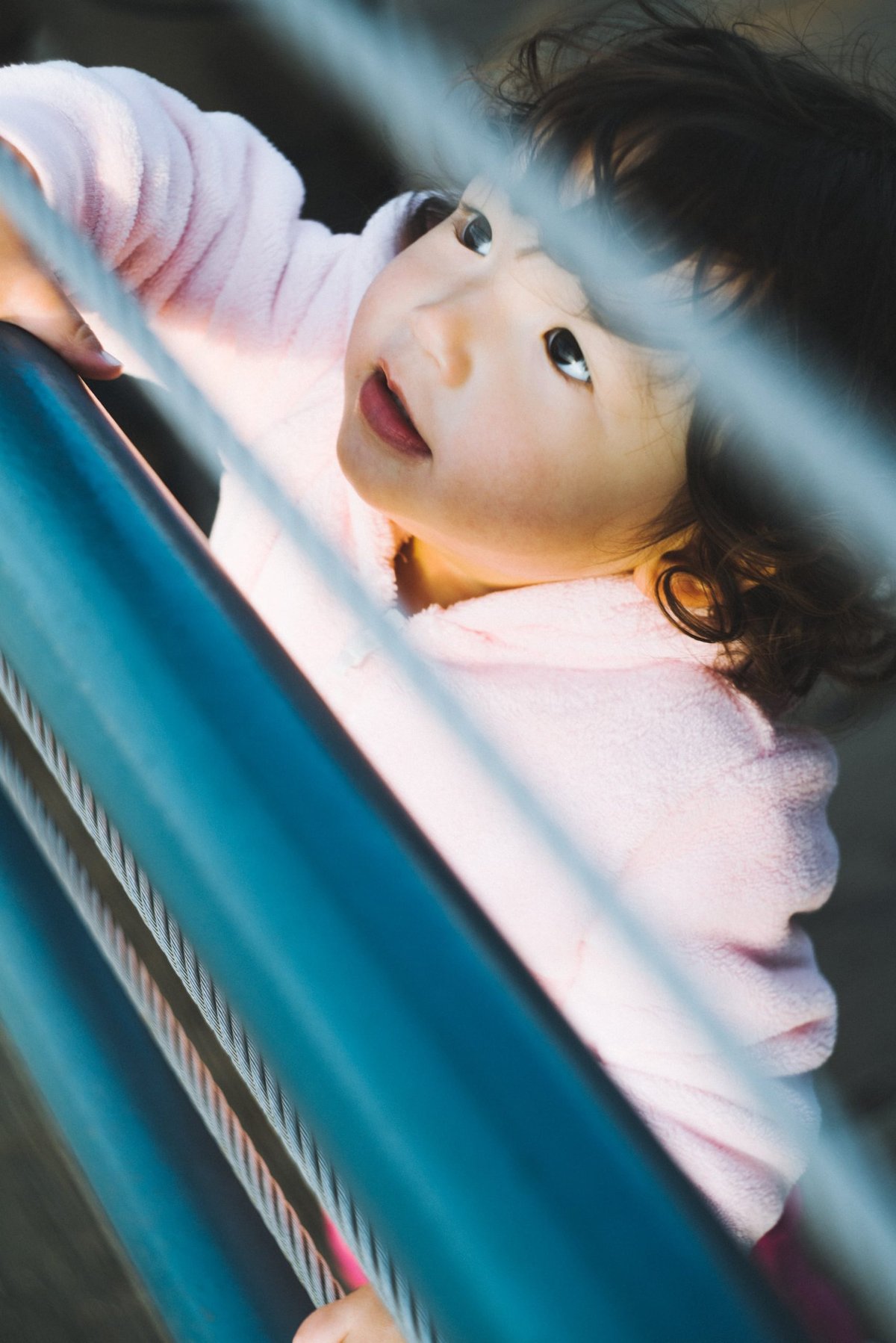 girl looking up between gate