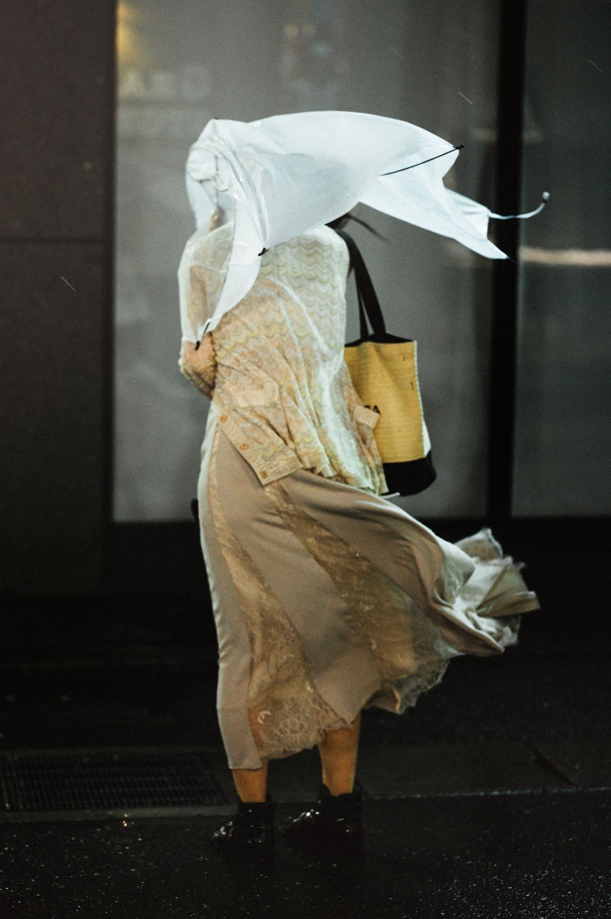 woman with a destroyed umbrella in the rain