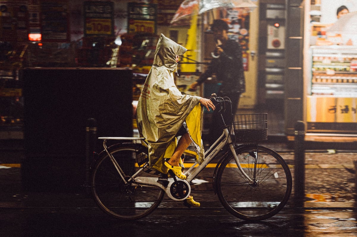 woman riding bike in the rain
