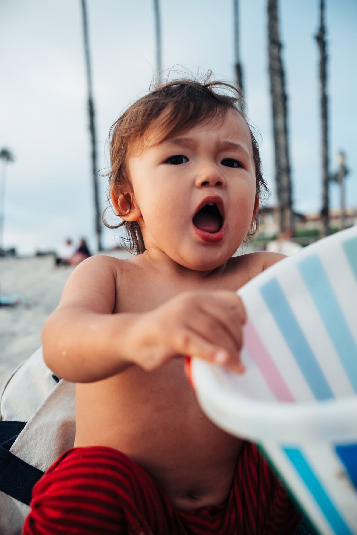 Luka plays with bucket.