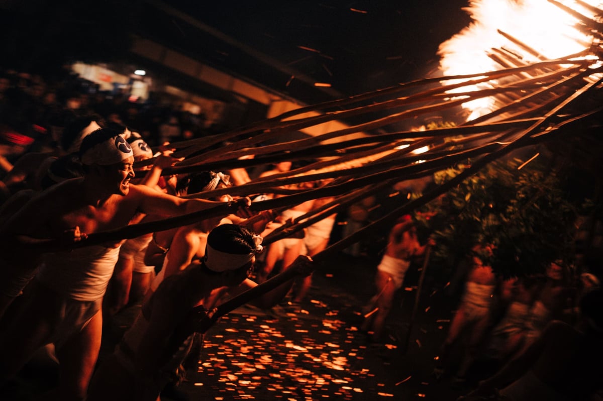 Men work together to move giant torch.