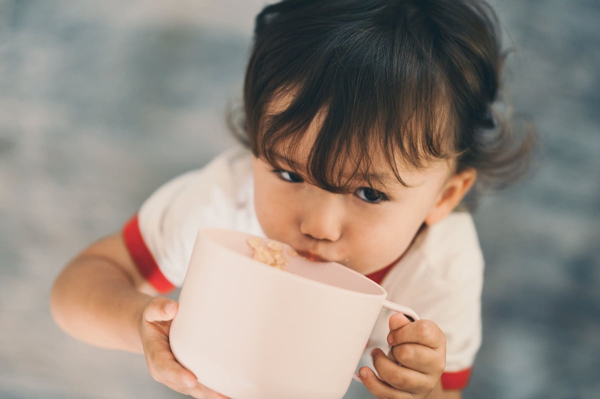 Luka drinking from giant cup.