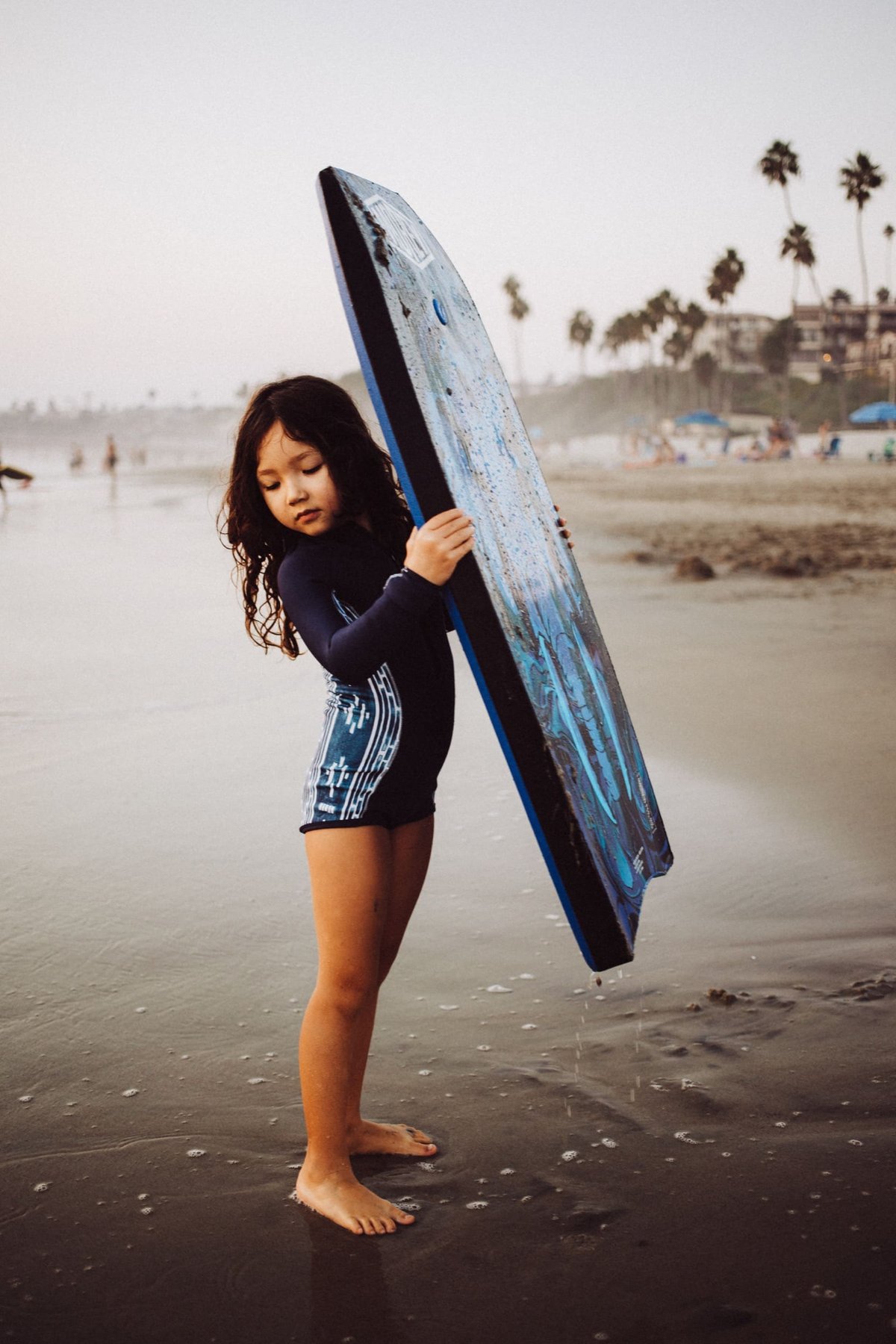 Kalina holding body board