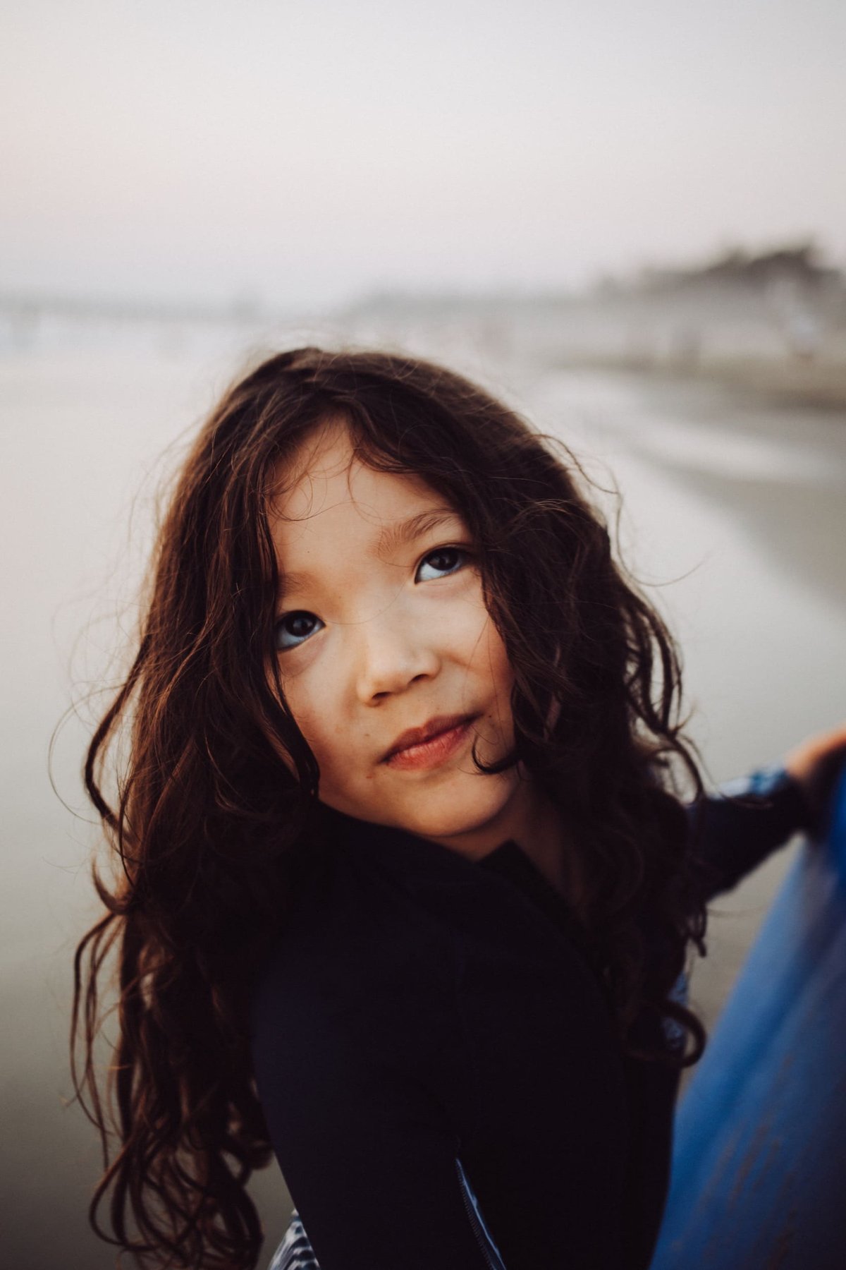 girl holds body board