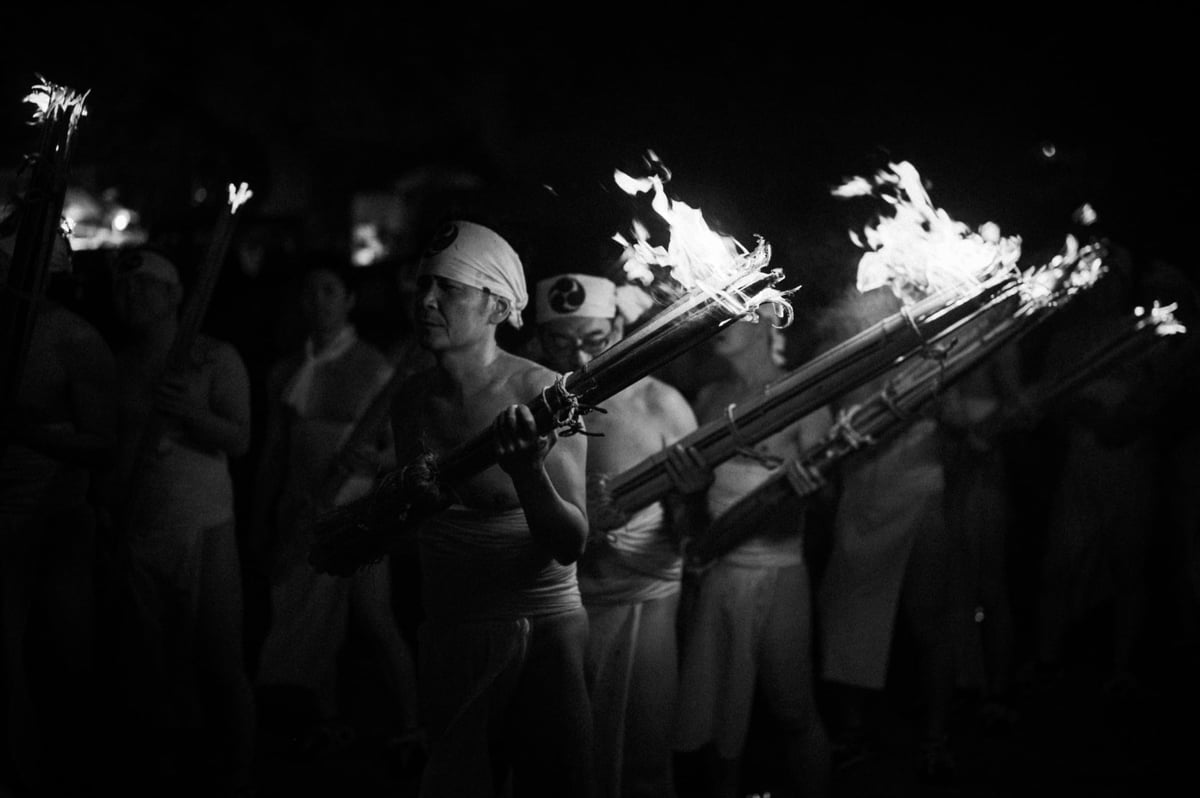 Black and white photo of group marching at the Oniyo Fire Festival