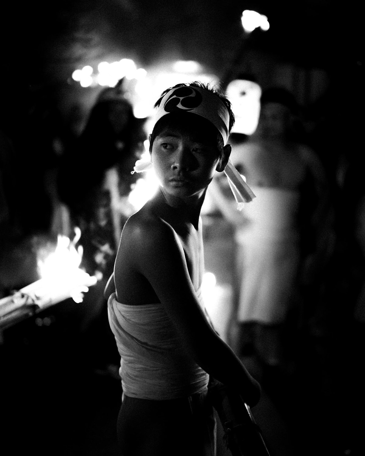 boy standing in front of fire