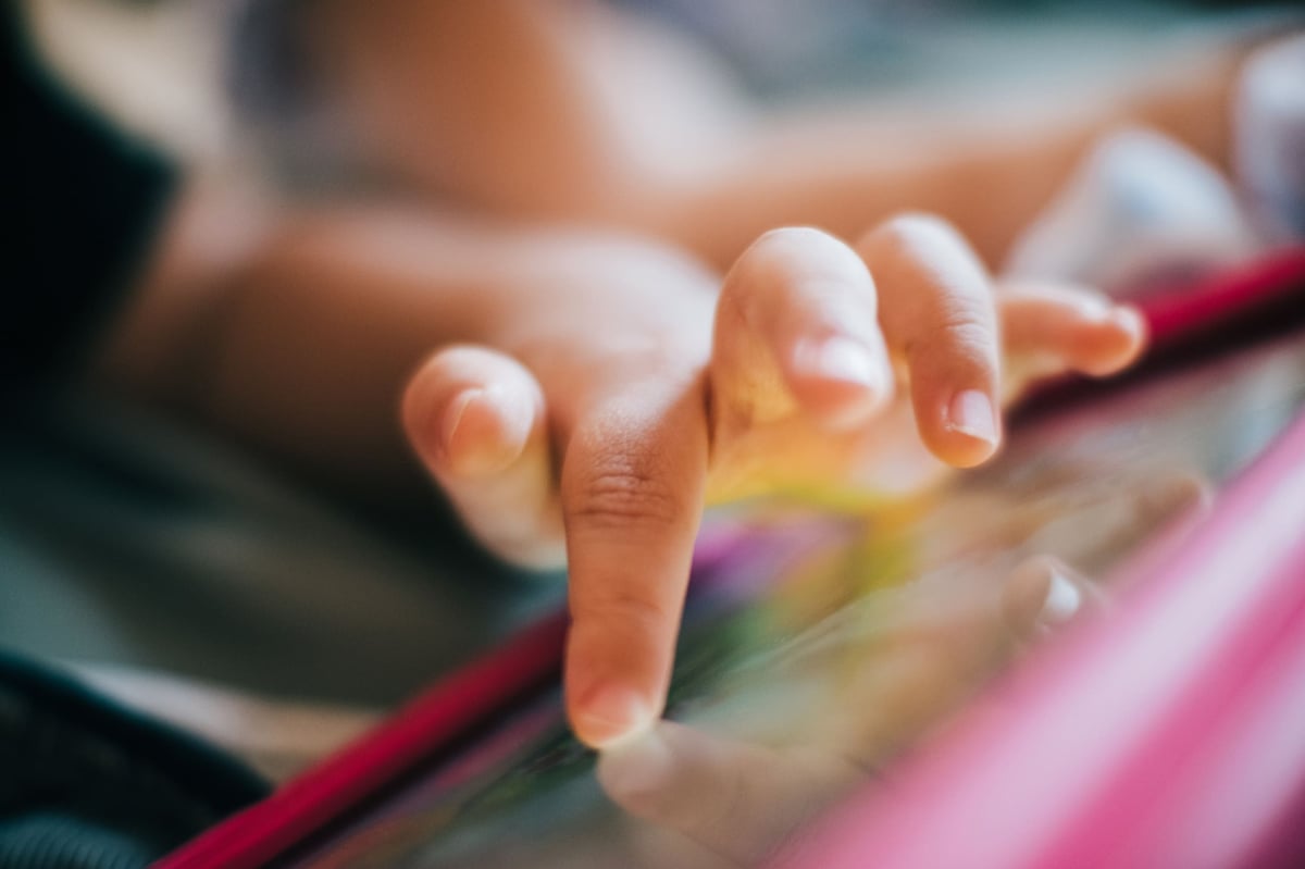 closeup of a finger pressing on the tablet