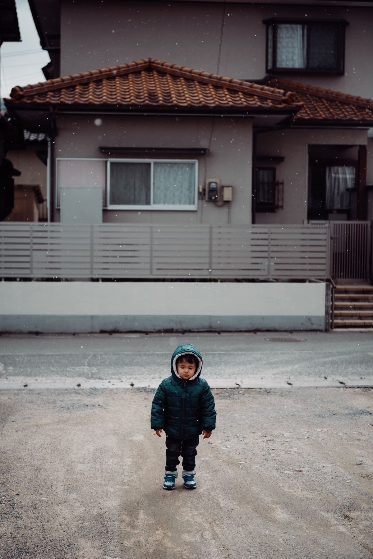 boy standing in snow,