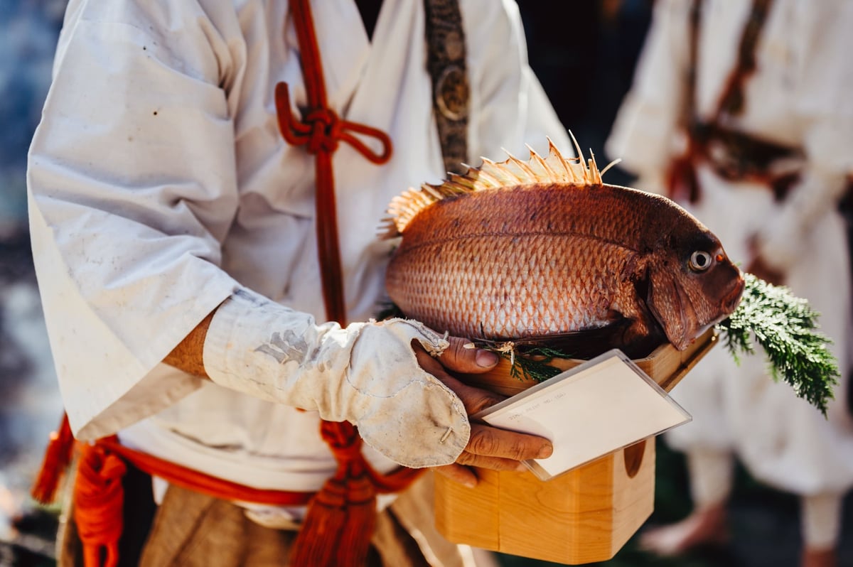 Monk holds red snapper
