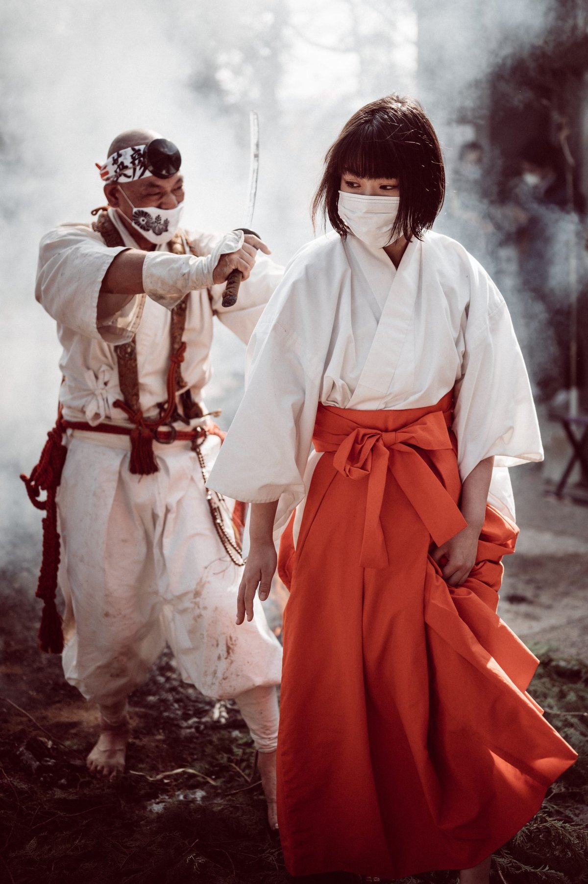 Atago Fire Festival Monk walks woman through fire