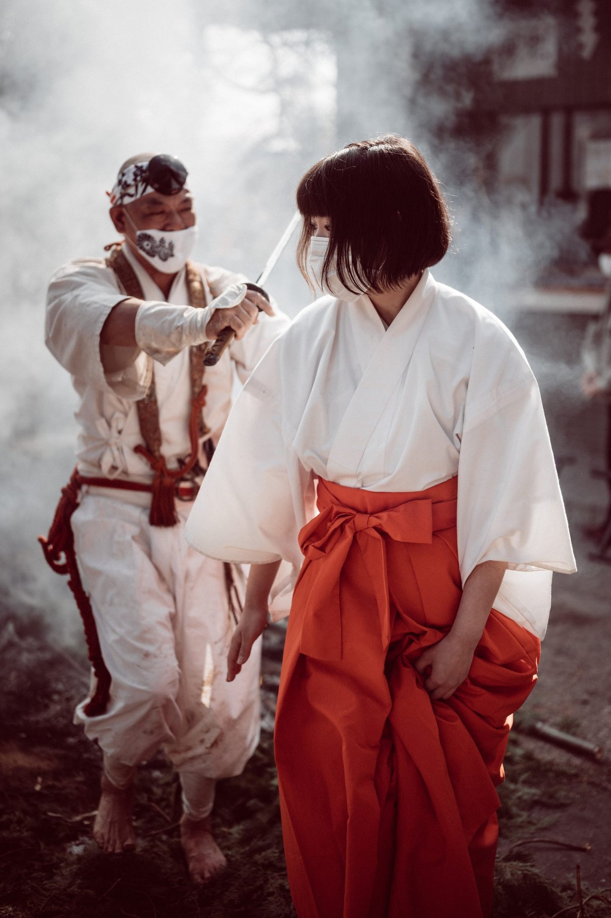 monk escorts woman through fire