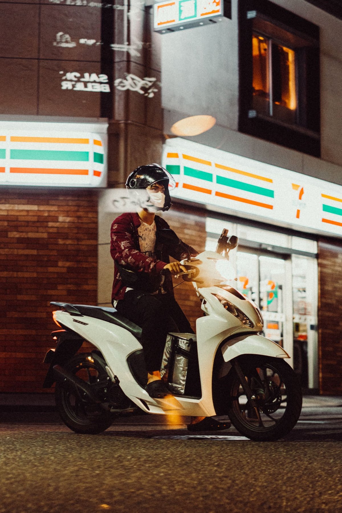 Japan street photo of a man on a motorcycle.