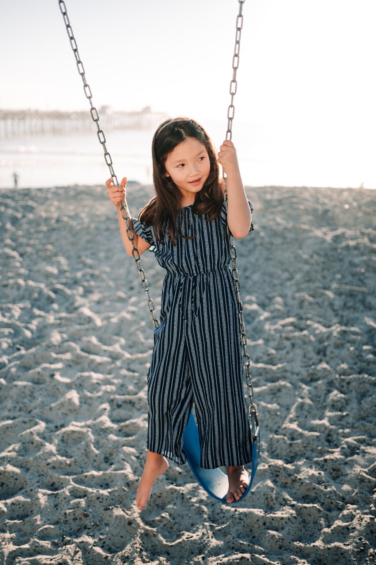 Kalina on a swing at San Clemente Beach.