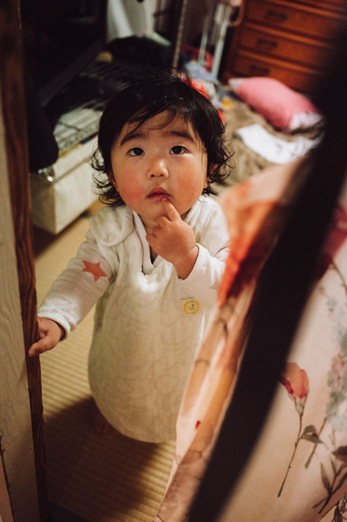 Little Japanese Girl looking up into camera.