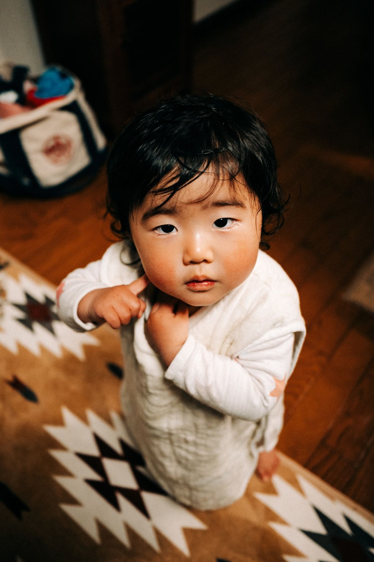 Little Japanese Girl looking up into camera.