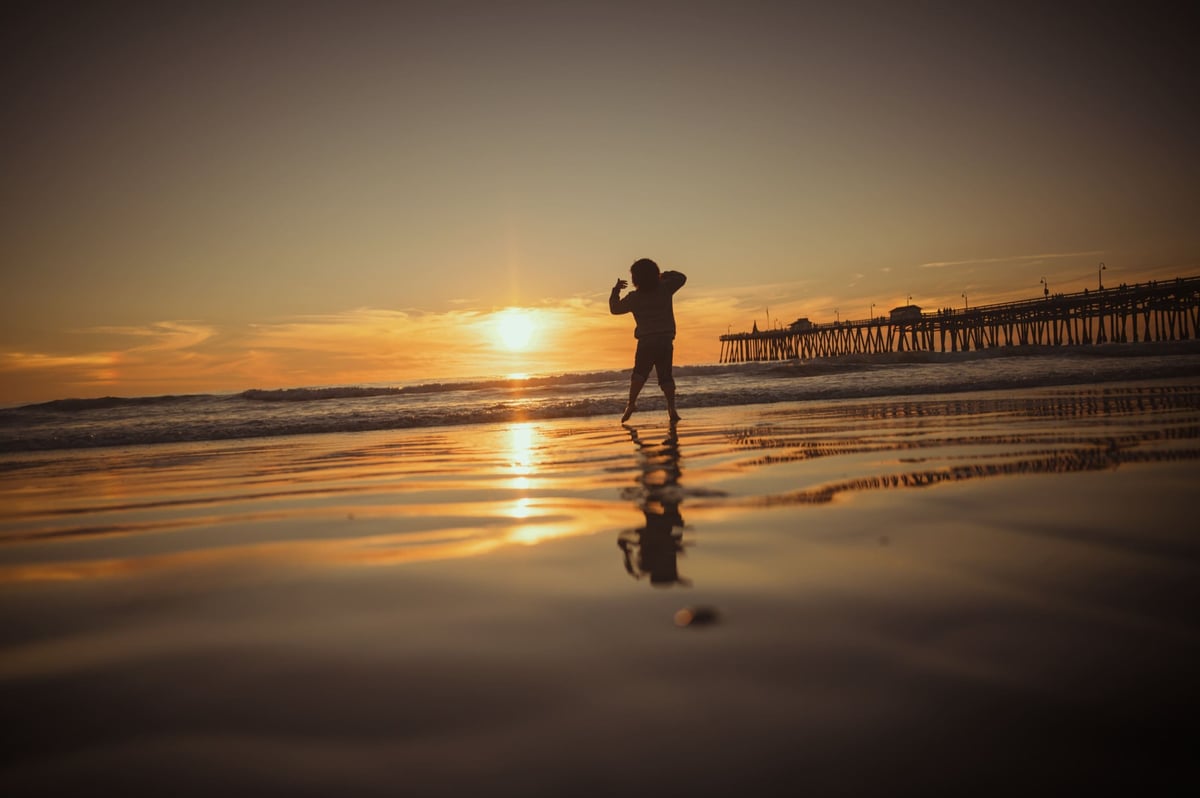 Kids playing on the beach at the San Clemente Pier.