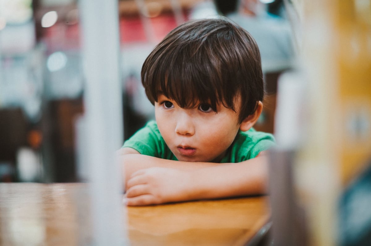 Lifestyle photo of little boy posing with with very shallow depth of field.