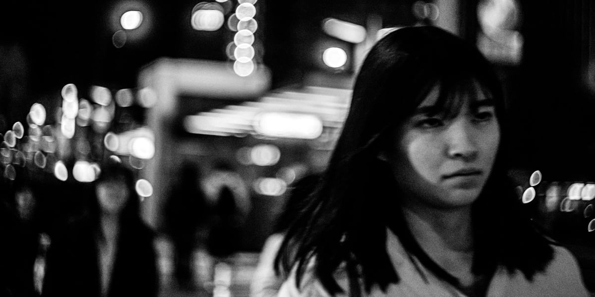 Girl in Tenjin Japan with a 2:1 cinematic crop, shot with the Helios 44-2 Lens at f2.