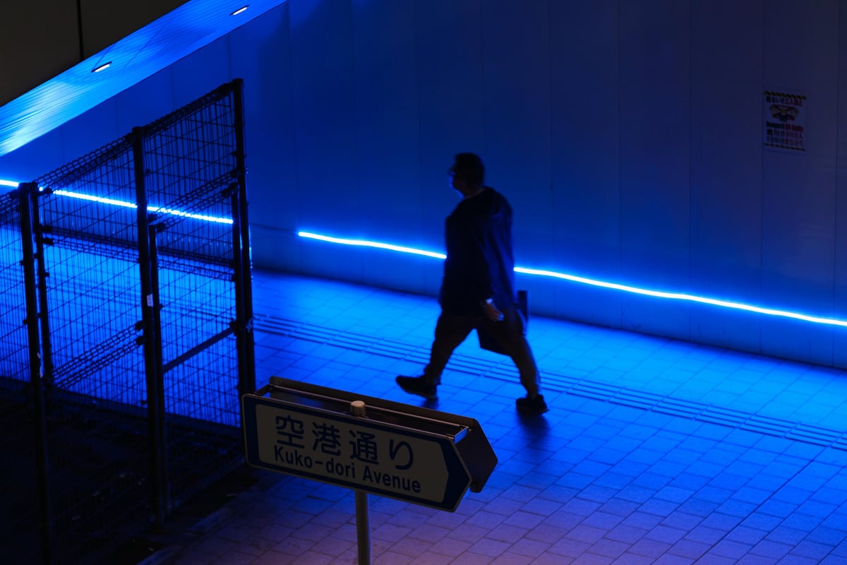Man walking in a blue lit area